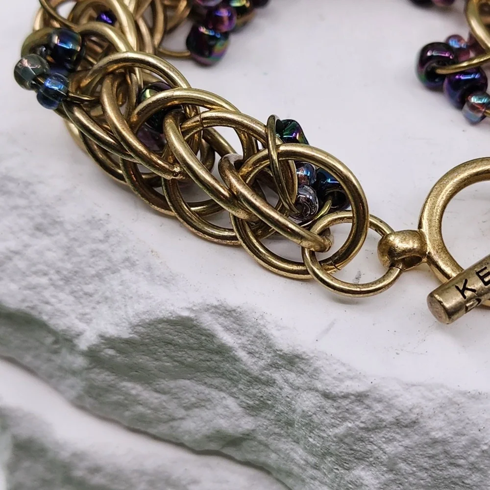 Kenneth Cole Gold Tone Woven Ring Bracelet Purple Bead Chunky Toggle Statement